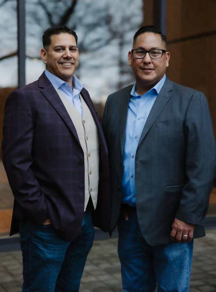 Two First Nations Pallet Solutions and Ha'no:wa:h executives standing together outside an office building in Atlanta.